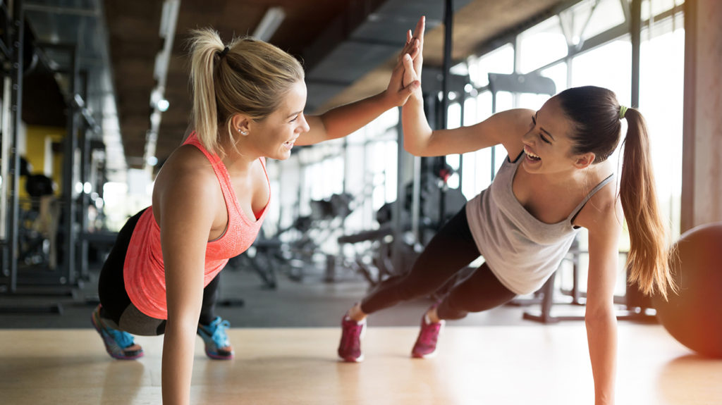 Beautiful women working out in gym together